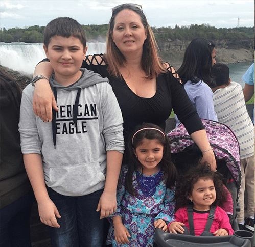 Alysha Yepes smiling with her son and two daughters at Niagra Falls