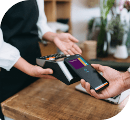 A man uses mobile wallet on his smart phone to pay at a payment device