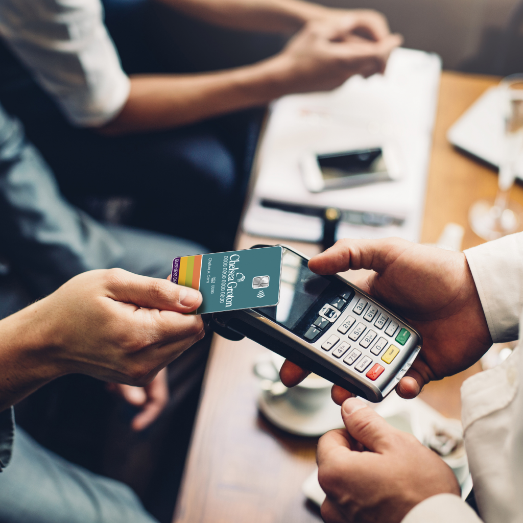 A business customer making a purchase with their Contactless Chelsea Groton Debit card.